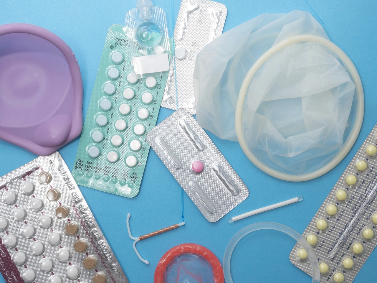 Condoms, contraceptive pills and other reproductive health supplies arranged together.