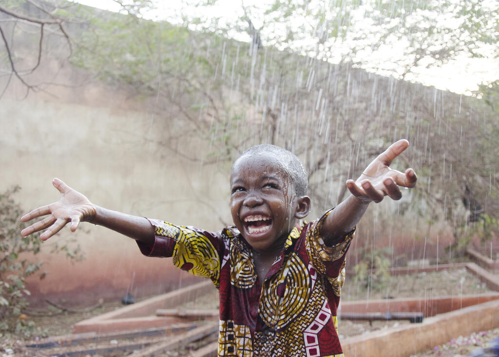 Sweet Little African Boy Under The Rain In Mali (africa)