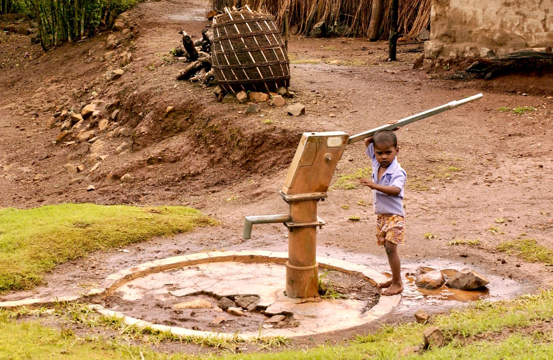 Little boy pumping water in India