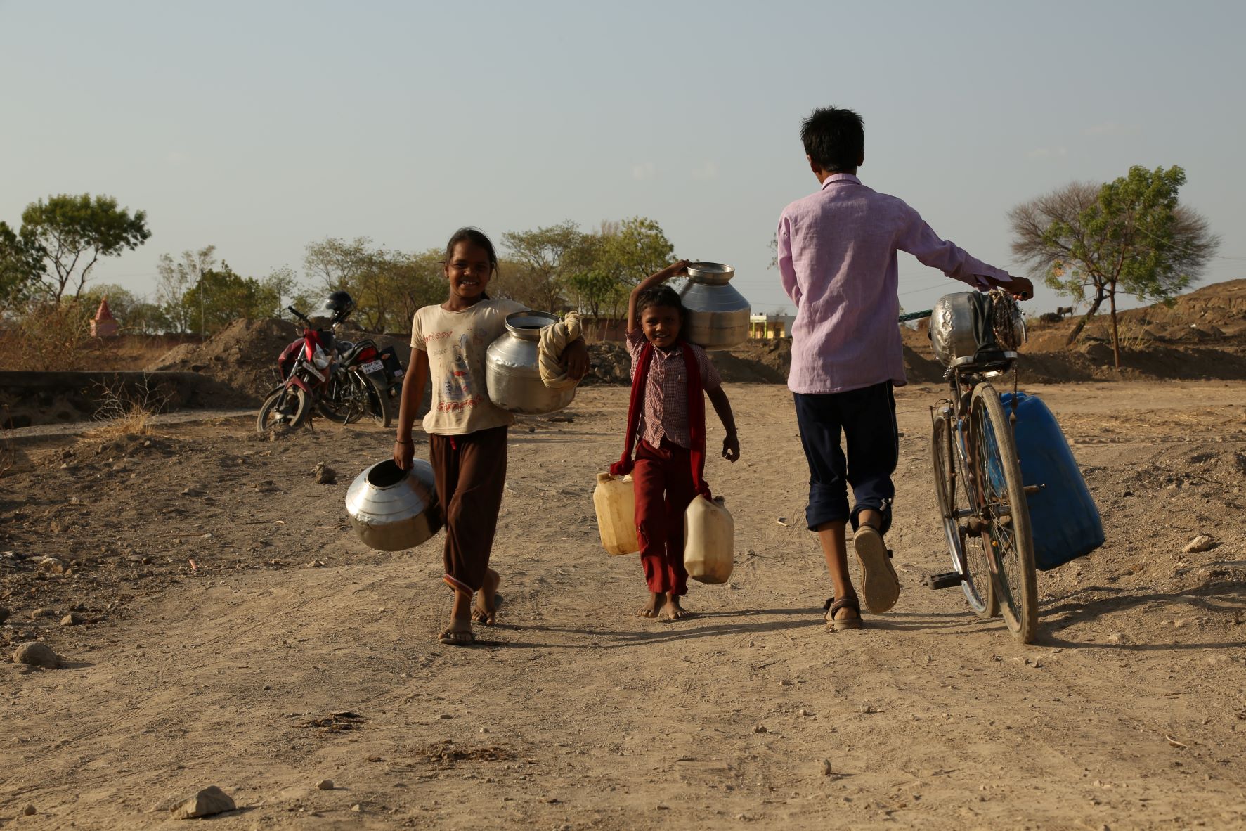 Indian kids carrying vessels