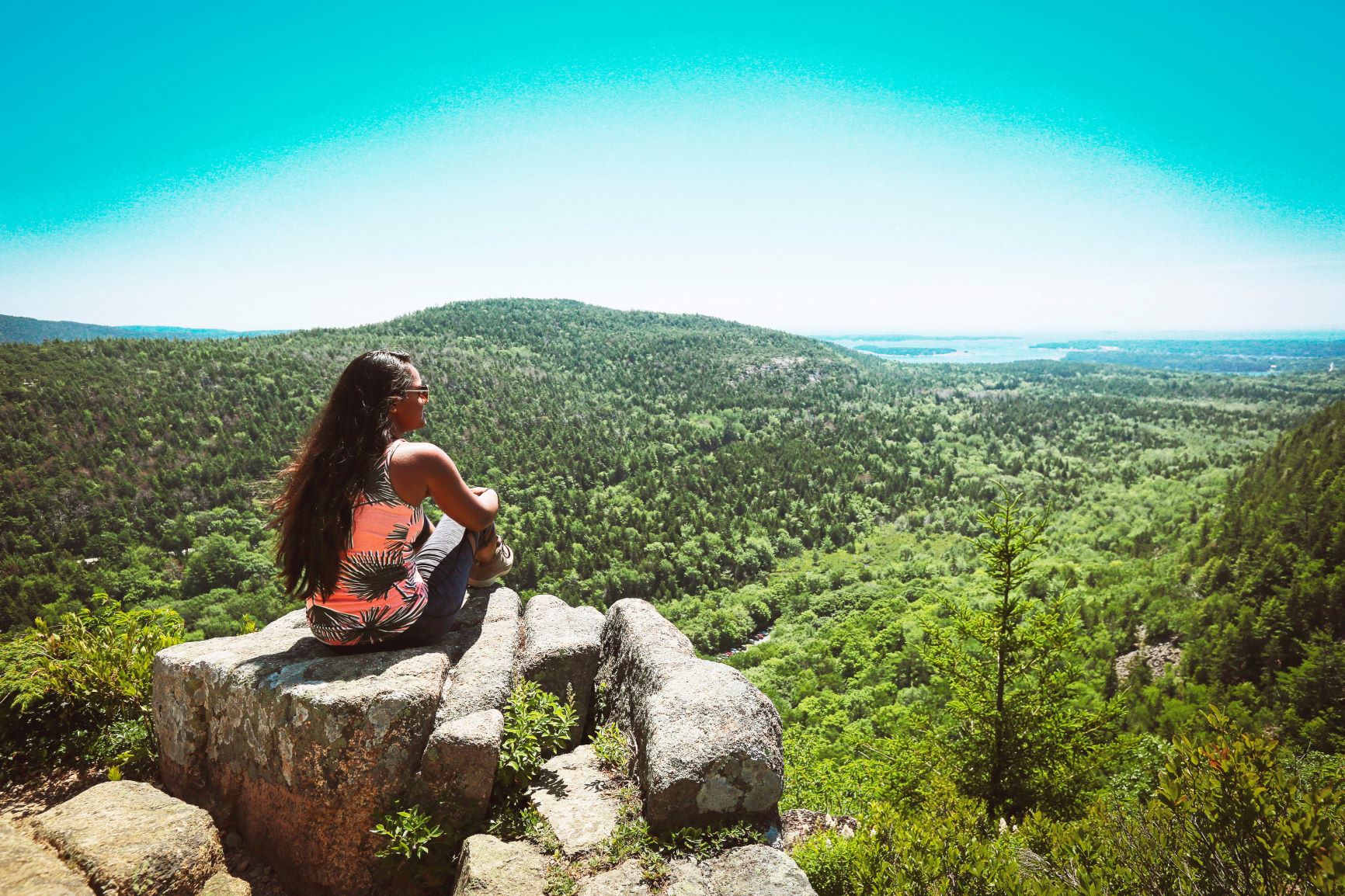 Woman sitting on rock