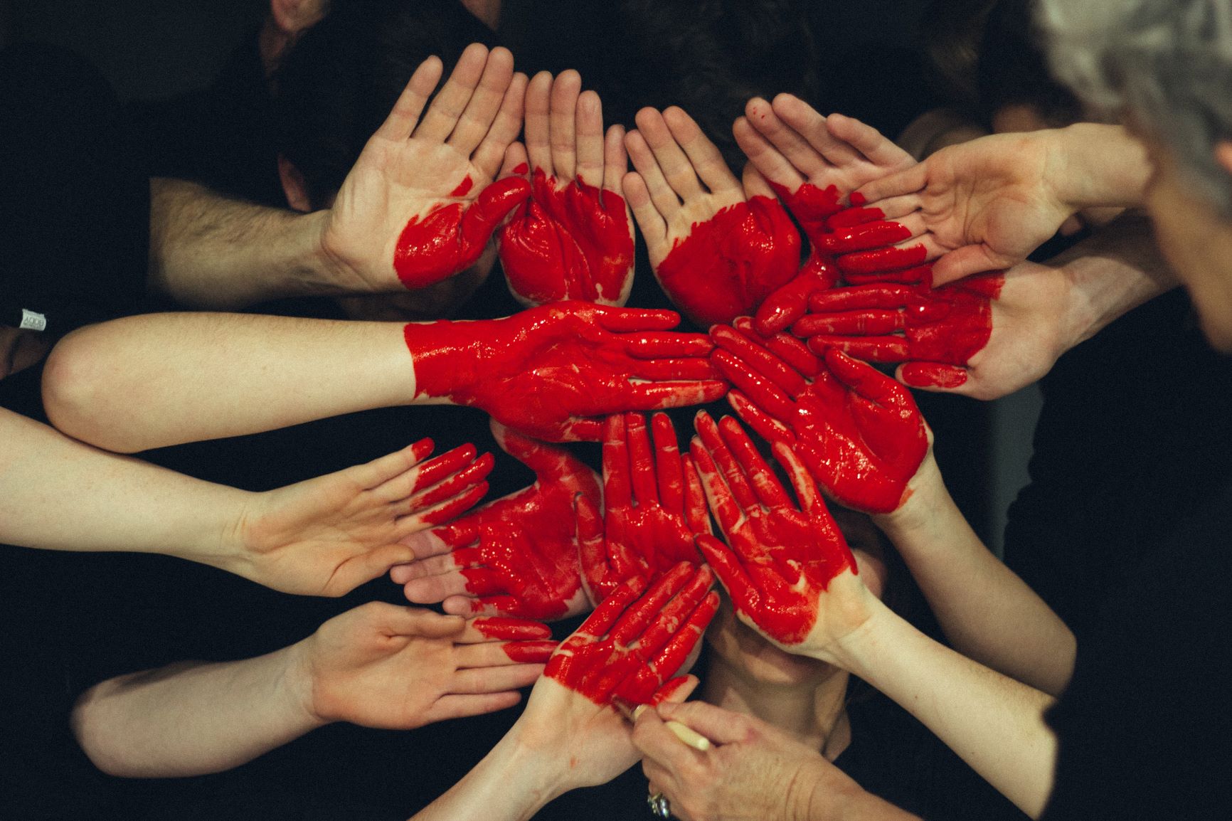 Heart made of red painted hands