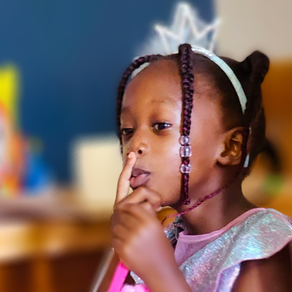 A child with silencing finger on mouth 