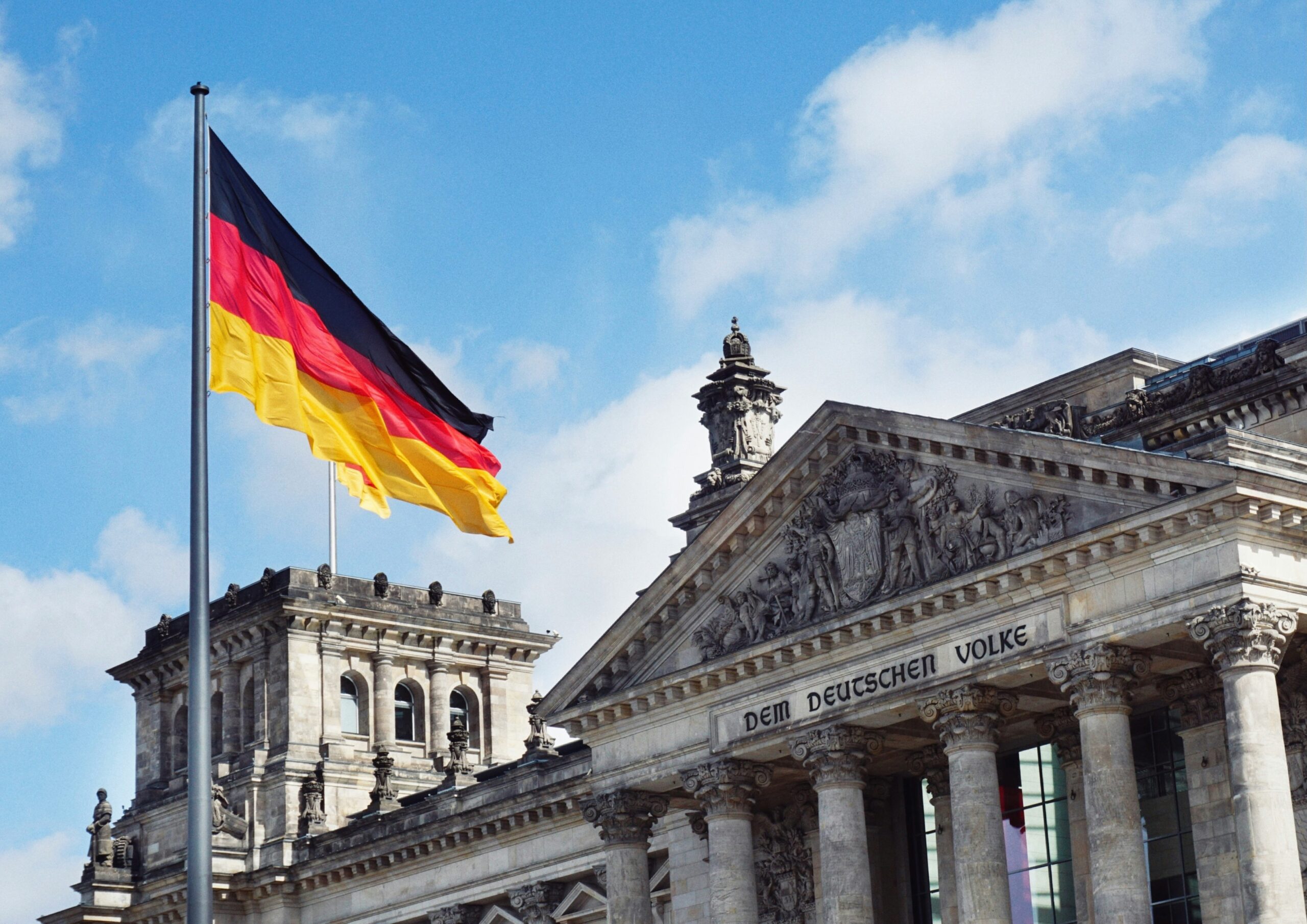 German flag flies next to the Reichstag