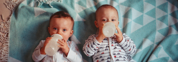 Two babies with bottles
